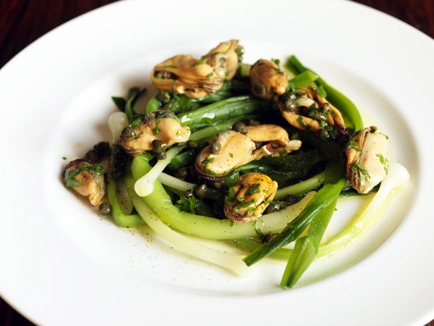 Arrange the leeks on the dish, scatter the mussels over and spoon on the dressing