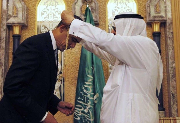 Barack Obama is presented with a gift from King Abdullah at the start of talks in 2009