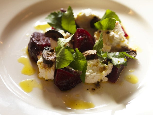 Arrange the beetroot, goat's curd or goat's cheese and the salad leaves in serving bowls or plates, season lightly and spoon over the dressing