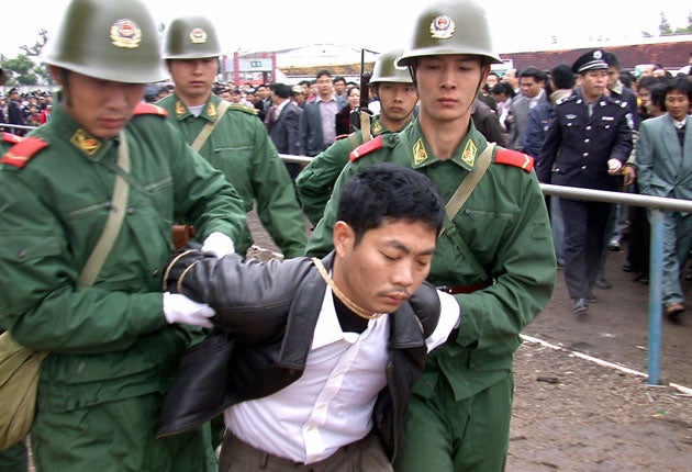 A prisoner is escorted for execution at a public rally in Zhanjiang in China’s Guangdong province