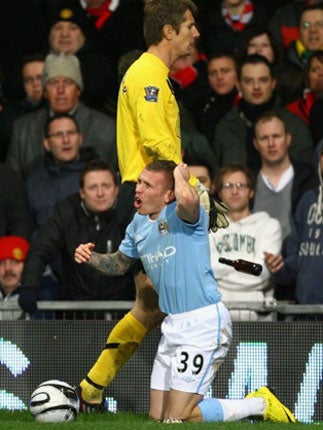 Bellamy fell to the ground at Old Trafford after he was struck by a coin