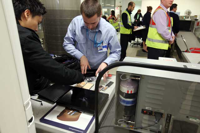 Airport staff combing through hand luggage