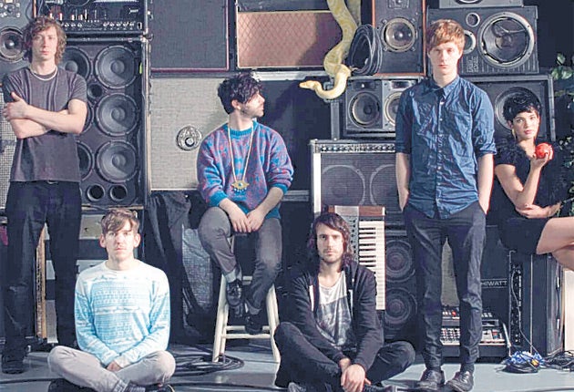 Have Foals found God? The new press photo circulating for the Oxford five-piece includes a sixth person; a woman holding an apple.