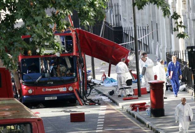 Forensic investigators examine the wreckage of the bombed bus after the July 7 bombing in London in 2005