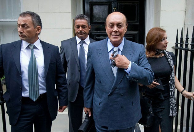 Asil Nadir (second from right) and his wife, Nur, leave their temporary home in central London