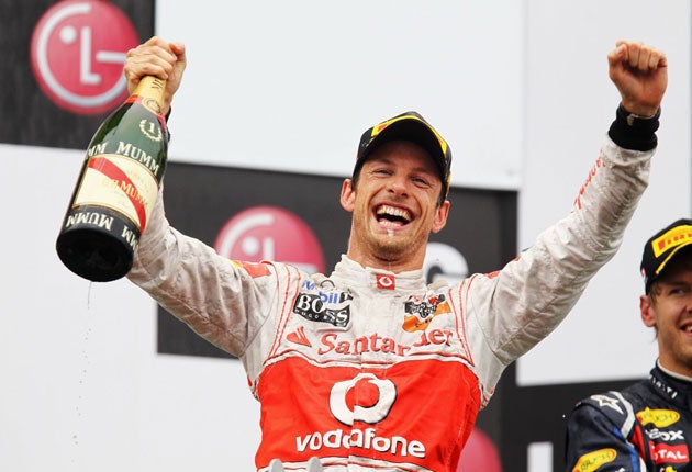 McLaren's Jenson Button celebrates his miraculous win in the rain-hit Canadian Grand Prix