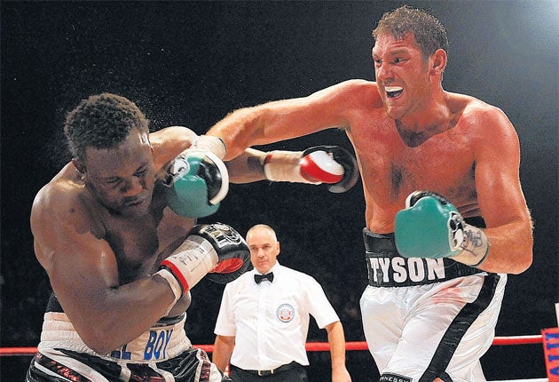 Tyson Fury (right) lands a right hook on Dereck Chisora in an impressive display at Wembley Arena in their first fight in 2011