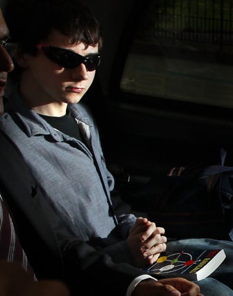 Jake Davis, clutching a copy of the book Free Radicals, leaves Westminster magistrates' court yesterday