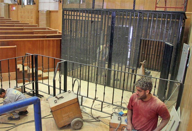 Workers prepare the courtroom for the trial of Hosni Mubarak