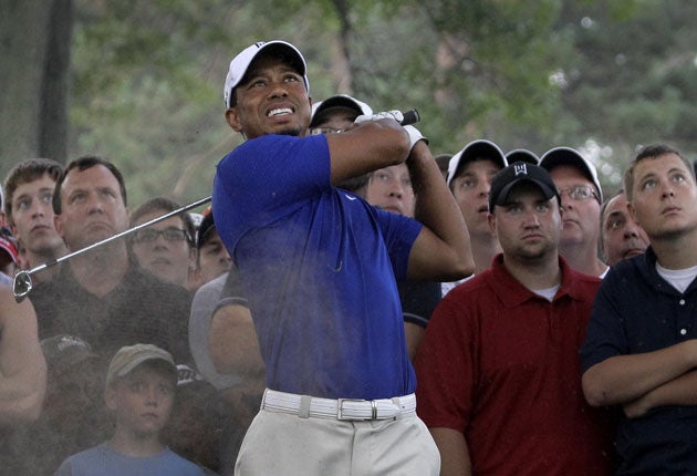 Feeling blue: Spectators watch the former world No 1 Tiger Woods, on his way to a tie for 38th after the third round of the WGC Bridgestone Invitational