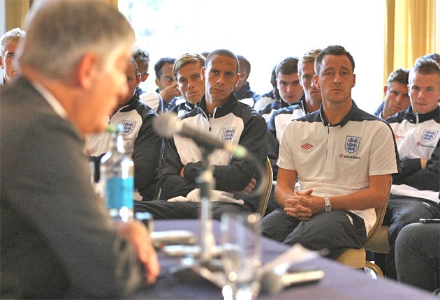 England players listen to David Bernstein yesterday as he addresses the media about the cancellation of tonight's friendly