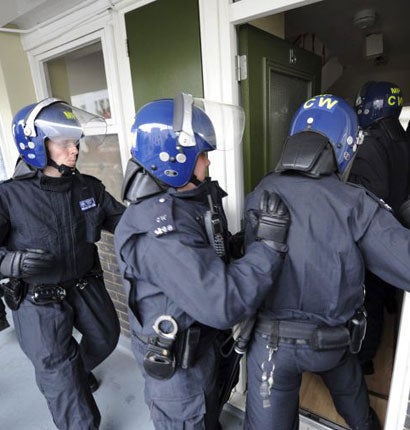 Police officers raid a property in Pimlico, London