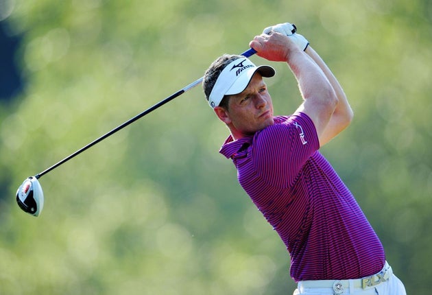 Luke Donald hits a tee shot on the 14th