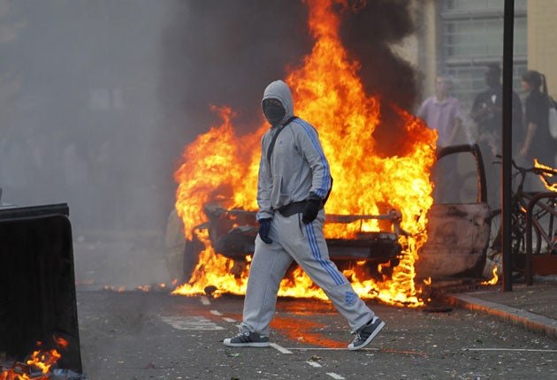 A masked rioter on the streets of Hackney last week