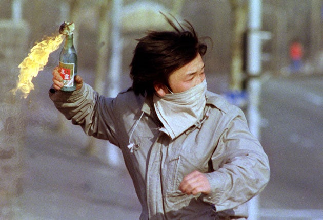 A student throws a petrol bomb in Seoul in 1988