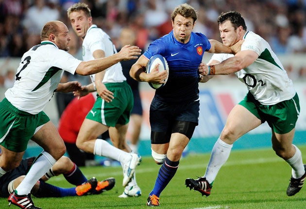 Vincent Clerc, the France winger who scored the only try of the match, hands off the Ireland loosehead prop Cian Healy in Bordeaux