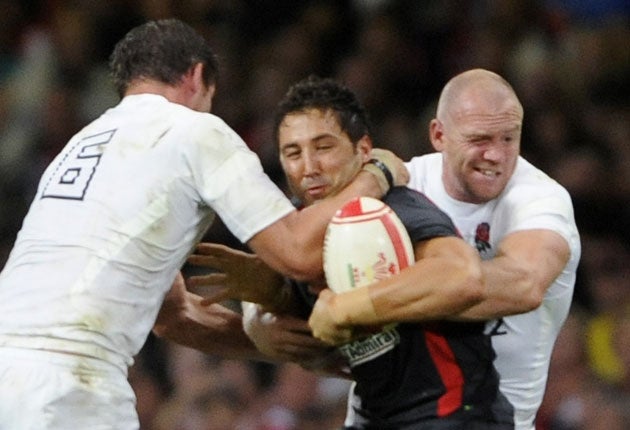 Gavin Henson is tackled by England's Tom Wood and Mike Tindall on Saturday