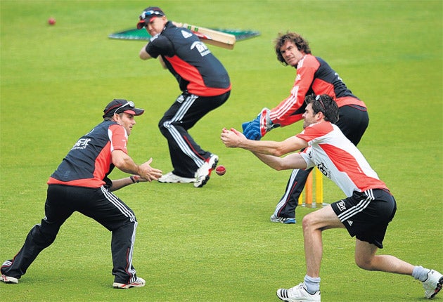 England coach Andy Flower gives captain Andrew Strauss (left) and bowler James Anderson slip catching practice at The Oval yesterday