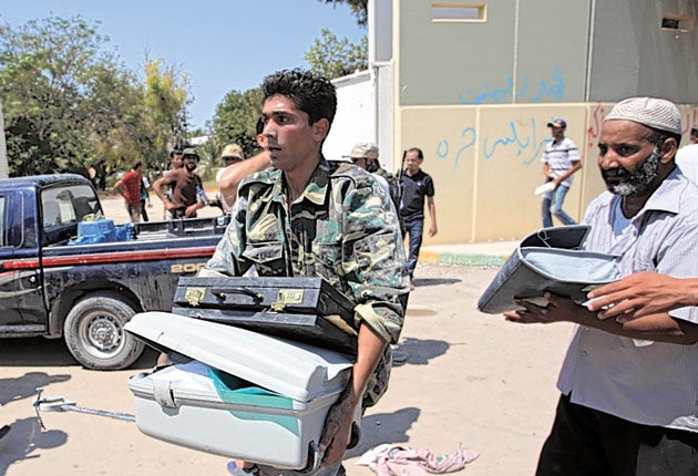 Rebel fighters inside Muammar Gaddafi's Bab al-Aziziya compound
made off with luggage