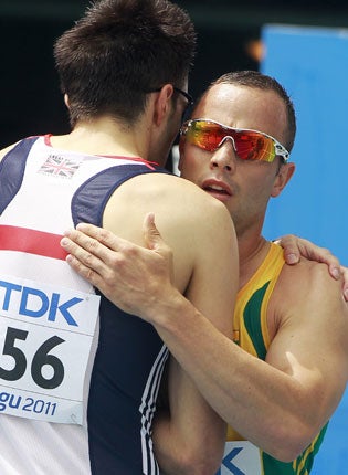 Martyn Rooney (left) and Oscar Pistorius were training together just weeks before the shooting