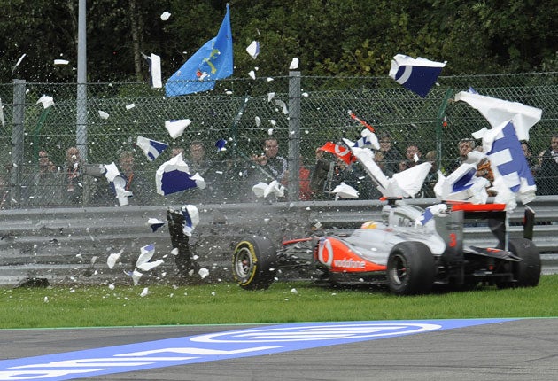 Lewis Hamilton crashes through an advertising hoarding into the barrier to end his race