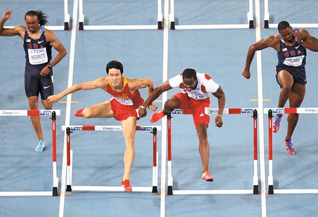 Cuba's Dayron Robles (second right) makes contact with Liu Xiang during the men's 110m hurdles final