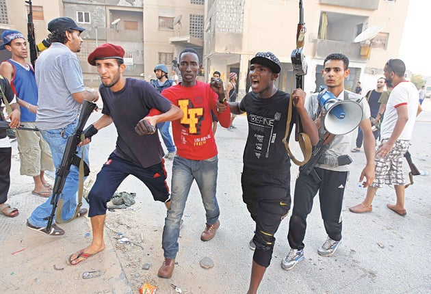 A Gaddafi loyalist is detained by rebel forces in Tripoli