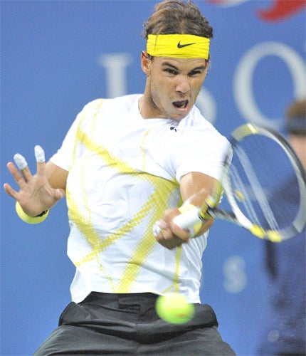 Spain's Rafael Nadal, sporting bandages on his burnt fingers, returns to Kazakhstan's Andrey Golubev at Flushing Meadows