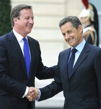 David Cameron is welcomed by France's president Nicolas Sarkozy prior to meeting members of Libya's National Transitional Council (NTC) in Paris