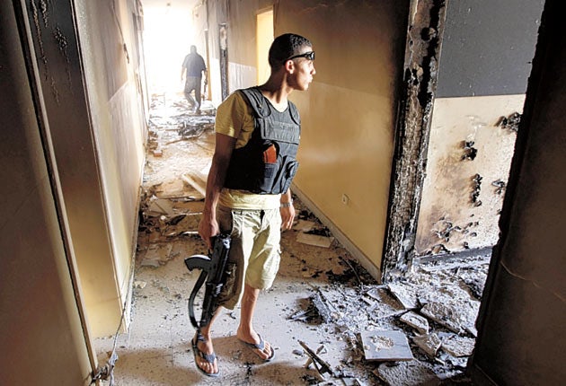 Anti-Gaddafi fighters in the Burkan air defence military base, which was
destroyed by a Nato air-strike