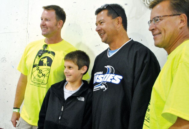 Nate Smith and his father, right, pose for a photo after his incredible shot