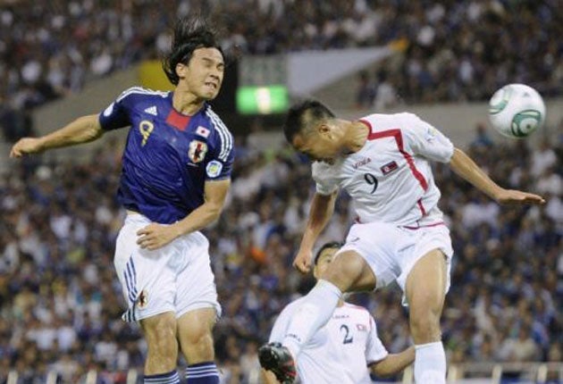 Japan's Shinji Okazaki (left) challenges North Korea's Chong Tese