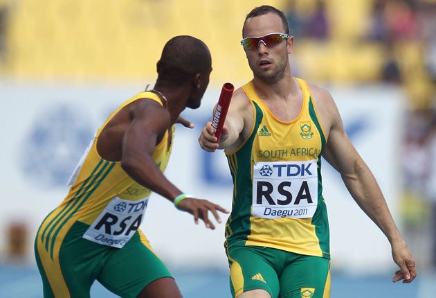 Oscar Pistorius hands on the baton during an earlier relay round in Daegu