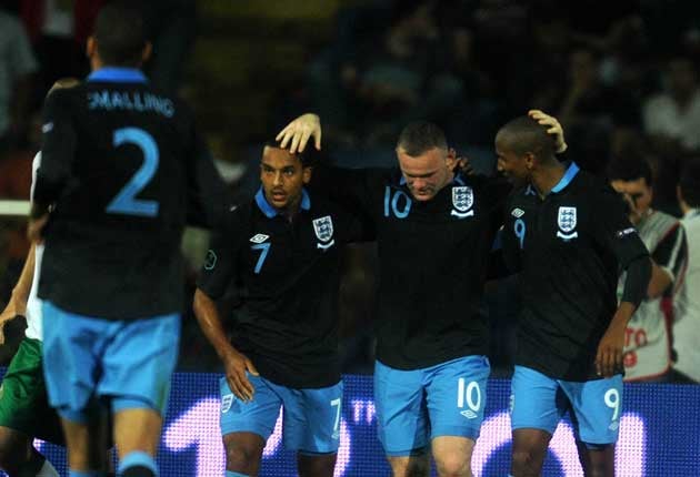 Rooney (C) celebrates with teammates after scoring against Bulgaria