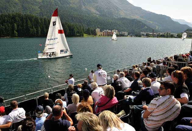 Chasing a dream, Ian Williams and Team GAC Pindar are left
behind by French semi-final opponent Pierre-Antoine Morvan (middle distance) watched by the crowd in St. Moritz for the World Match Race Tour