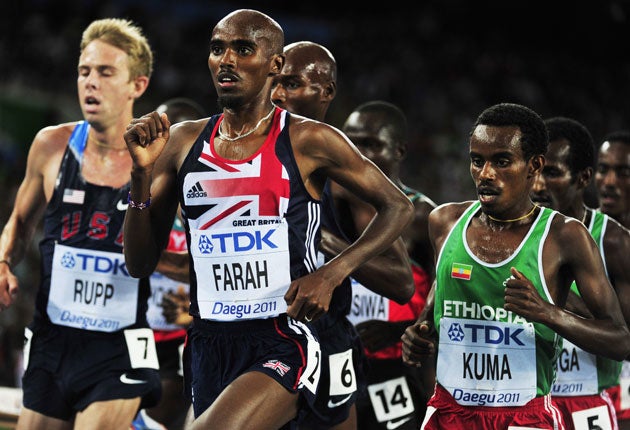 Britain's Mo Farah (centre) leads the field in the final of the 5,000m in Daegu yesterday