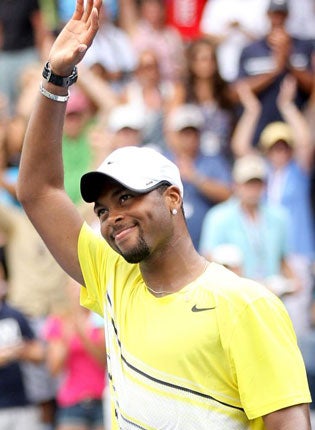 America's Donald Young salutes the crowd after knocking out Juan Ignacio Chela