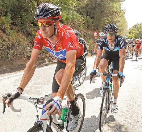 Bradley Wiggins (left) in the Tour of Spain’s red leader's jersey before his defeat on Sunday