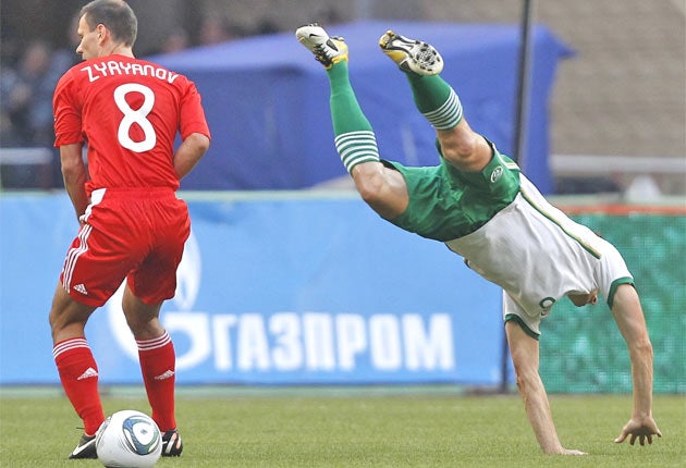 Ireland's Keith Andrews (right) goes flying during Ireland's draw last night