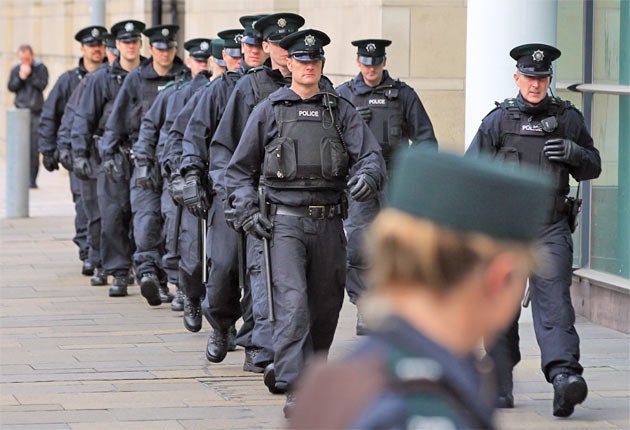 Police gather for the trial of loyalist gang members in Belfast in 2011