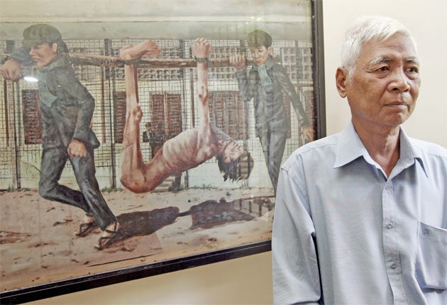 Vann Nath with one of his paintings at the Tuol Sleng genocide museum in Phnom Penh in 2007