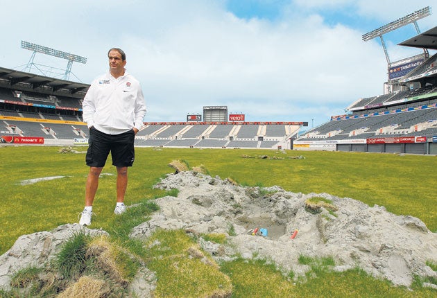 Martin Johnson inspects the damage caused to the AMI Stadium pitch by the Christchurch earthquake