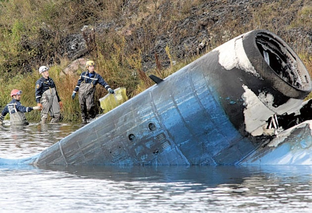 Rescuers at the scene of the crashed Russian Yak-42 jet yesterday