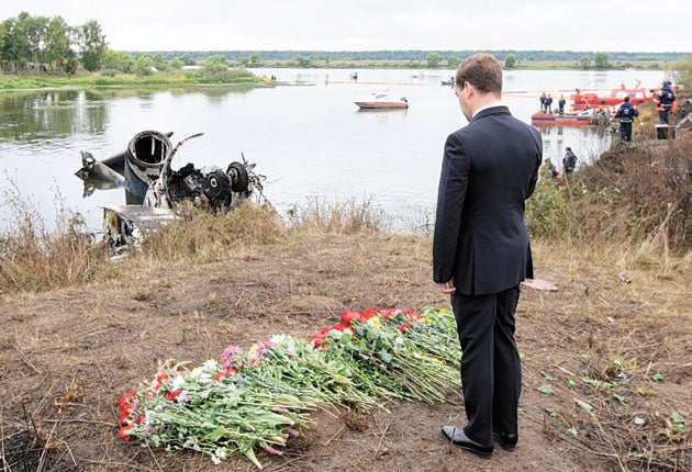 Russian President Dmitry Medvedev pays his respects at the crash site
