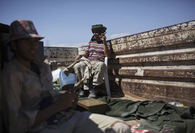 Soldiers fighting for the provisional government rest near the town of Bani Walid