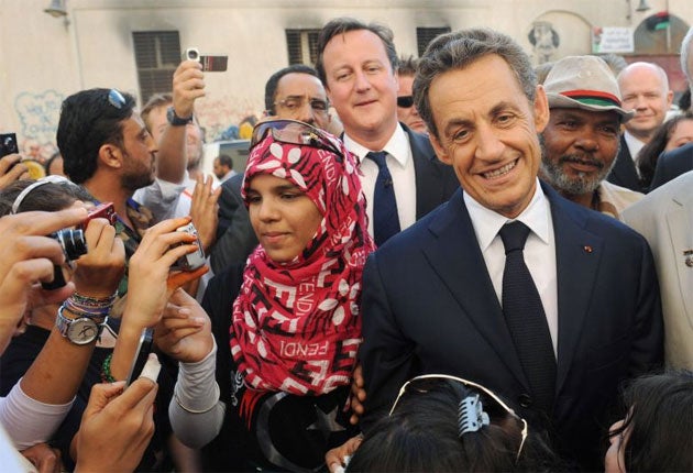 Nicolas Sarkozy and David Cameron during their visit to Tripoli in 2011 (Getty)