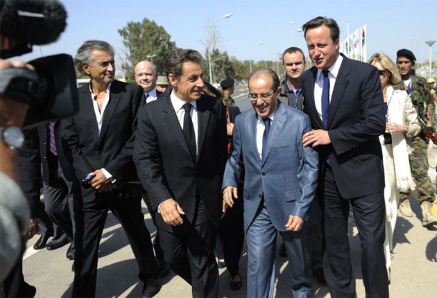 The French celebrity philosopher Bernard-Henri Lévy, left, was banned from joining the former President Nicolas Sarkozy’s, middle, visit to Libya