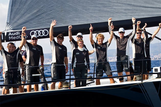 Arms raised in victory, the crew of Rán celebrates winning the Barcelona Trophy in the Audi MedCup finale