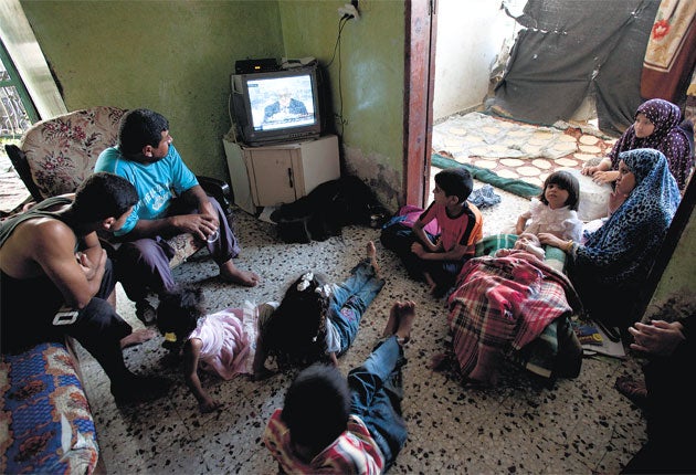 The Maher Elloh family watch President Mahmoud Abbas on TV in Beit Lahiya, Gaza Strip, on Friday. The Palestinian leader's bid for statehood is set to create a critical stand-off in New York