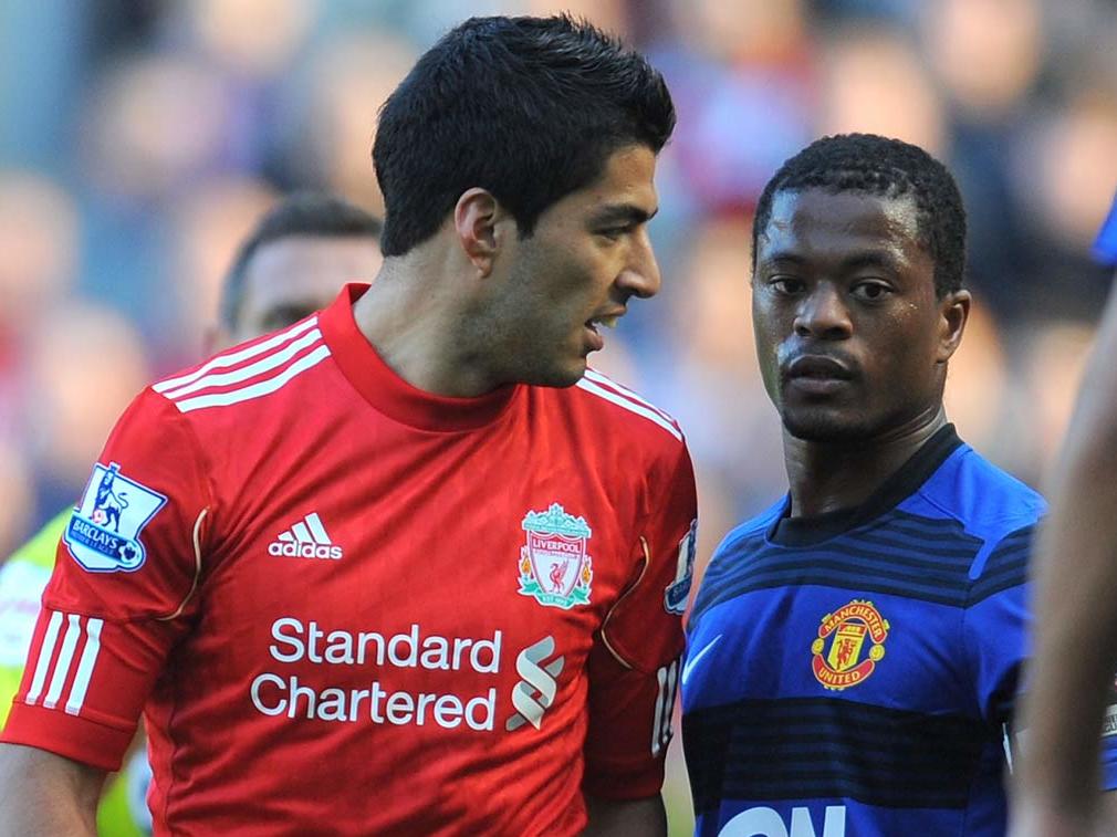 Suarez, left, was banned following the incident with Patrice Evra